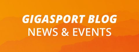 Sfondo arancione con silhouette di montagne. Il testo bianco recita "GIGASPORT BLOG NEWS & EVENTI".