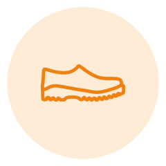 Disegno al tratto arancione di una scarpa su uno sfondo circolare beige chiaro. La scarpa ha un design semplice con una suola ondulata, tipica delle scarpe casual o sportive.