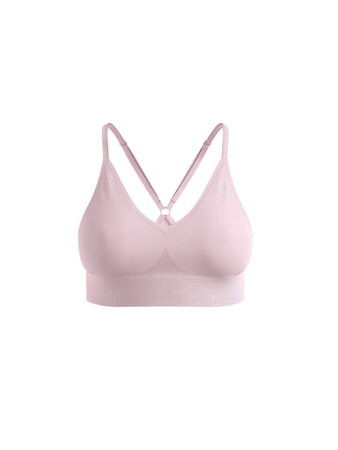 Bralette senza cuciture rosa chiaro con spalline regolabili incrociate su sfondo bianco.